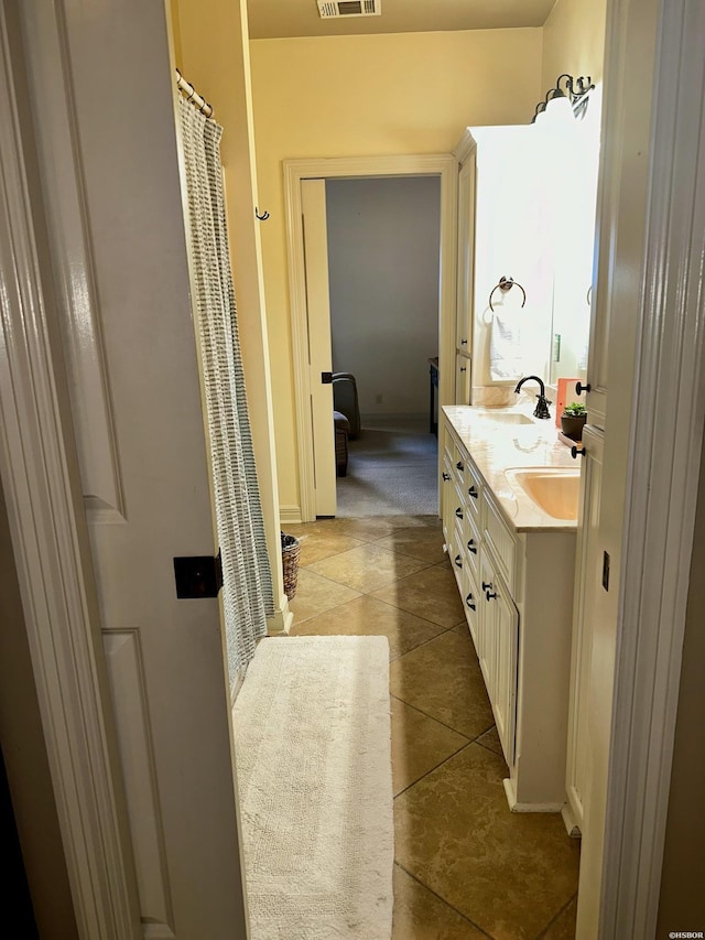 full bathroom featuring vanity, visible vents, and tile patterned floors