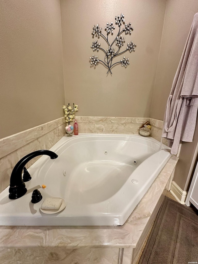 full bathroom with a jetted tub