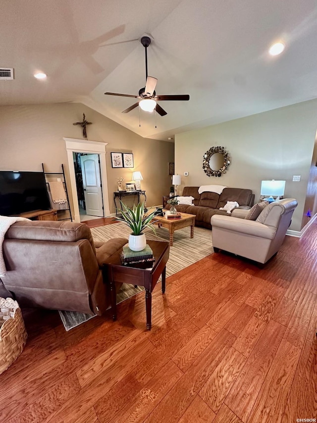 living room with lofted ceiling, ceiling fan, wood finished floors, visible vents, and baseboards