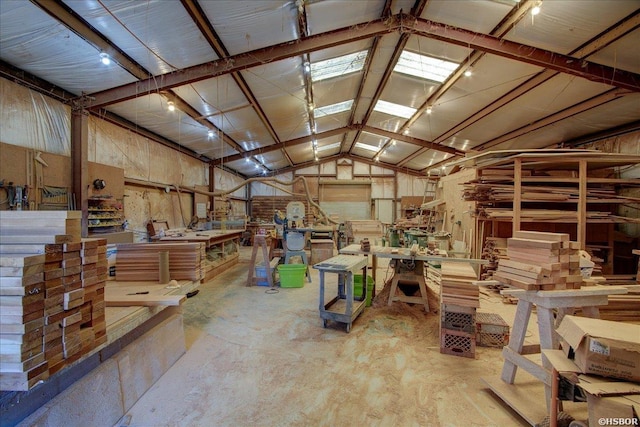 miscellaneous room featuring lofted ceiling and a workshop area