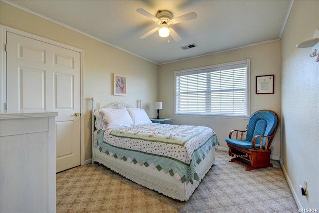 bedroom with light carpet, baseboards, visible vents, a ceiling fan, and ornamental molding