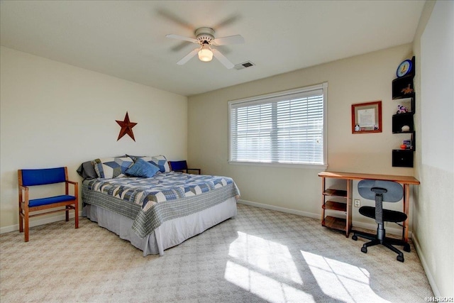 bedroom with light carpet, ceiling fan, visible vents, and baseboards