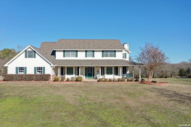 view of front facade with a porch, a chimney, and a front lawn