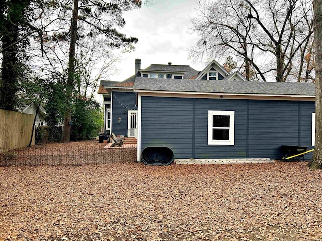 rear view of property with entry steps