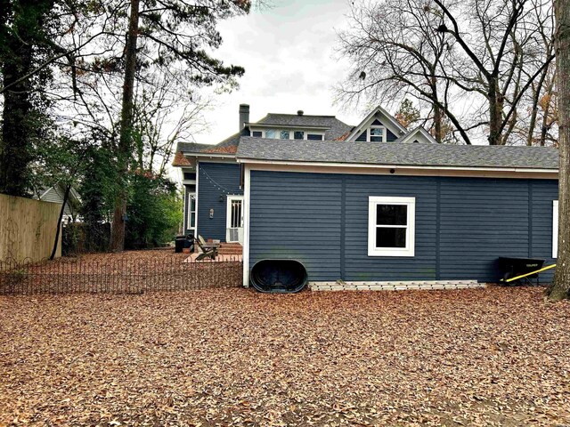 rear view of property with entry steps