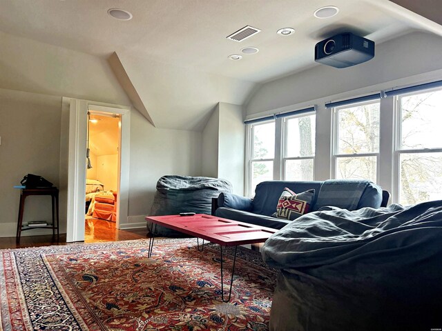 interior space featuring recessed lighting, wood finished floors, visible vents, baseboards, and vaulted ceiling