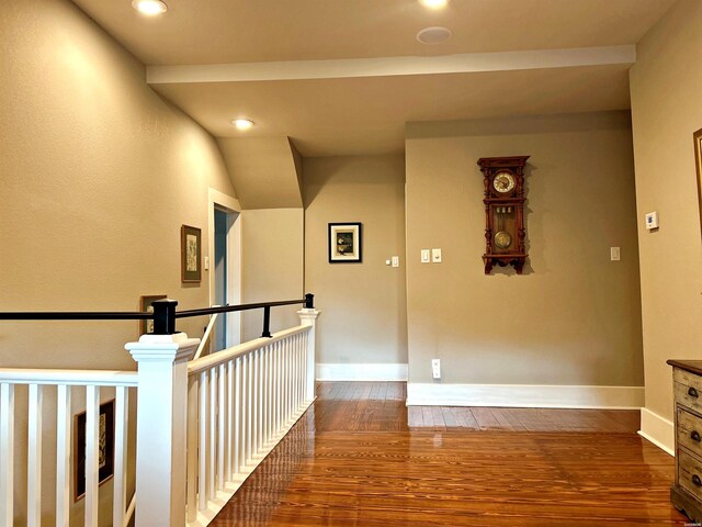 hallway with dark wood-style floors, recessed lighting, an upstairs landing, and baseboards