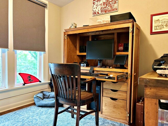 office area featuring baseboards and wood finished floors