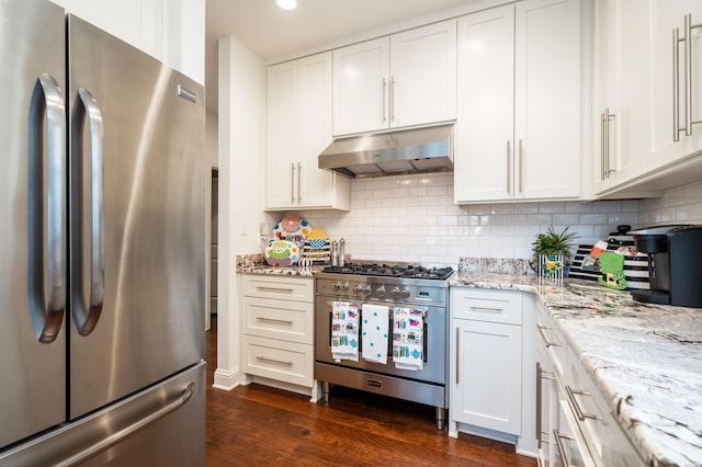 1129 Marion Anderson Rd, Hot Springs, AR 71913 - kitchen with appliances with stainless steel finishes, under cabinet range hood, dark wood-style floors, light stone counters, and white cabinets