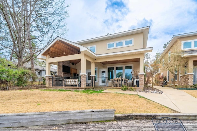 1129 Marion Anderson Rd, Hot Springs, AR 71913 - rear view of house featuring a porch, stucco siding, a yard, and brick siding