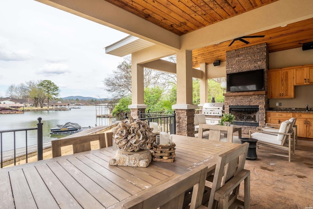 1129 Marion Anderson Rd, Hot Springs, AR 71913 - view of patio with a sink, an outdoor stone fireplace, and outdoor dining space