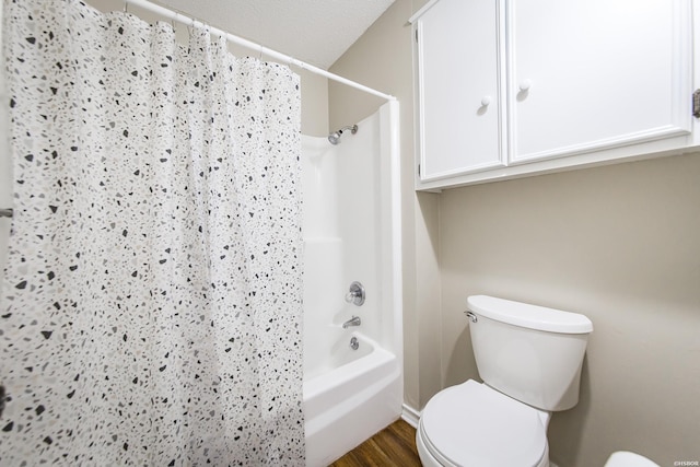 full bathroom featuring shower / bath combination with curtain, toilet, and wood finished floors