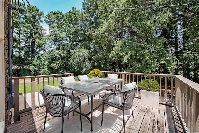 wooden terrace featuring outdoor dining space