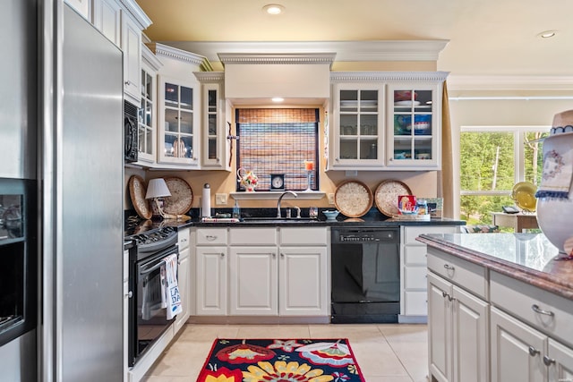 409 Halteria Ln Unit B, Hot Springs, AR 71913 - kitchen featuring black appliances, light tile patterned floors, ornamental molding, dark stone counters, and glass insert cabinets
