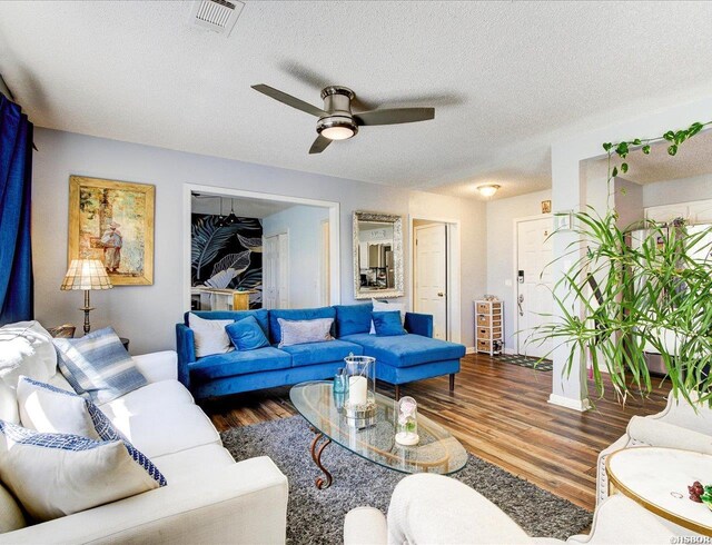 23 Ponferrada Way, Hot Springs Village, AR 71909 - living area with wood finished floors, ceiling fan, a textured ceiling, and baseboards