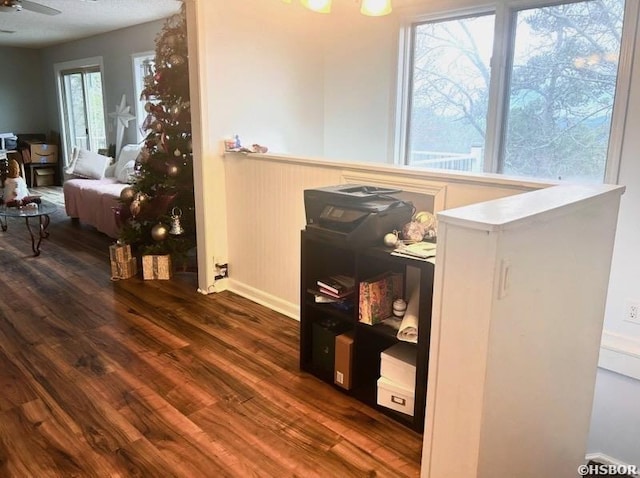 room details with ceiling fan, baseboards, and wood finished floors