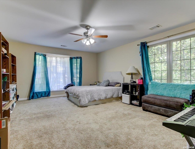 bedroom with multiple windows, carpet flooring, and visible vents