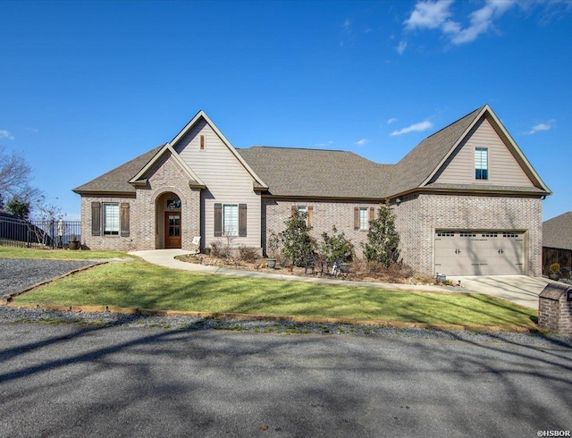 view of front of home with a garage, a front yard, concrete driveway, and brick siding