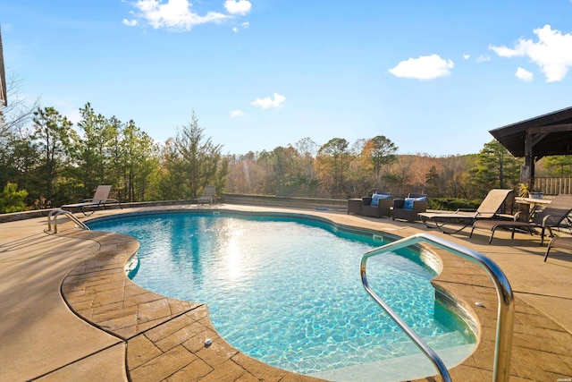 outdoor pool with a patio area