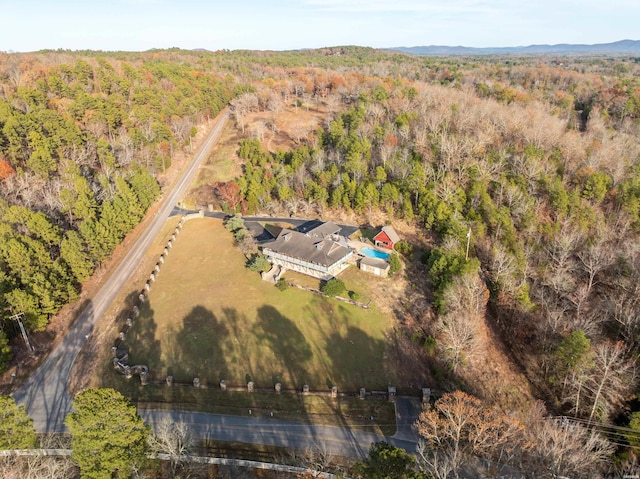 birds eye view of property featuring a wooded view