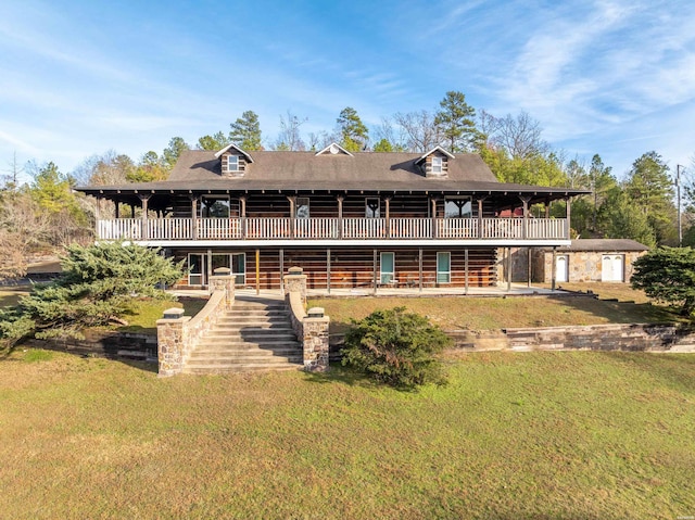 view of front of property with a front yard and a wooden deck