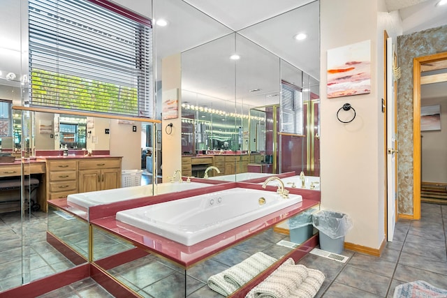 bathroom with baseboards, tile patterned floors, vanity, a bath, and recessed lighting