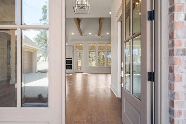 interior space featuring a chandelier, recessed lighting, beamed ceiling, and wood finished floors