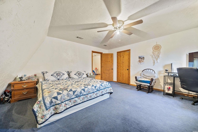 carpeted bedroom featuring a textured ceiling, a textured wall, visible vents, and a ceiling fan