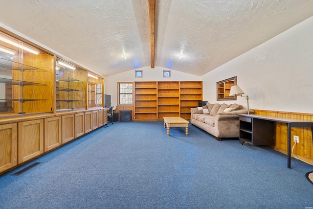 sitting room with lofted ceiling with beams, a textured ceiling, carpet flooring, and visible vents