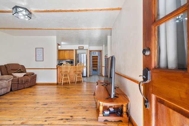 living room featuring baseboards and light wood-style floors