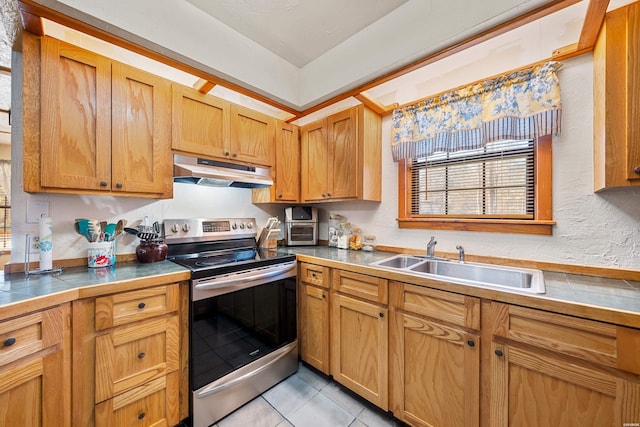 kitchen with light tile patterned floors, tile counters, under cabinet range hood, stainless steel range with electric stovetop, and a sink