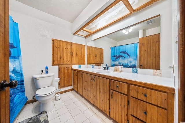 bathroom with visible vents, toilet, vanity, and tile patterned floors