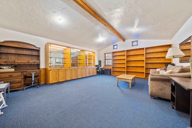 living area with vaulted ceiling with beams, dark colored carpet, a textured ceiling, and built in study area