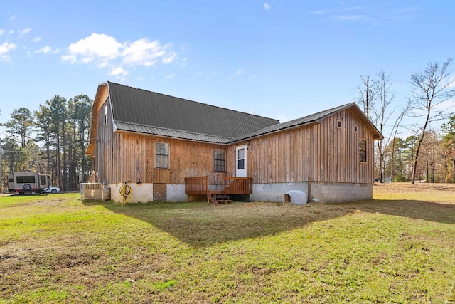 rear view of property with a yard, central AC, metal roof, and a gambrel roof