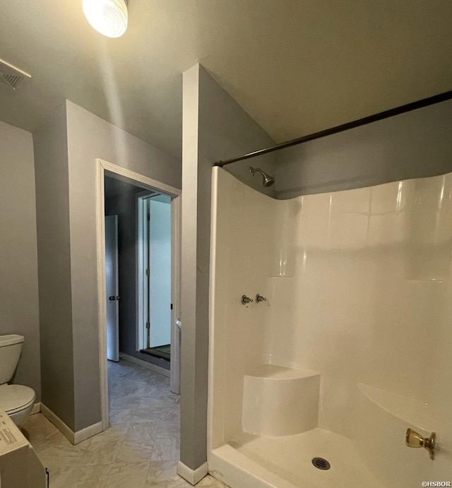 bathroom with toilet, walk in shower, visible vents, and baseboards