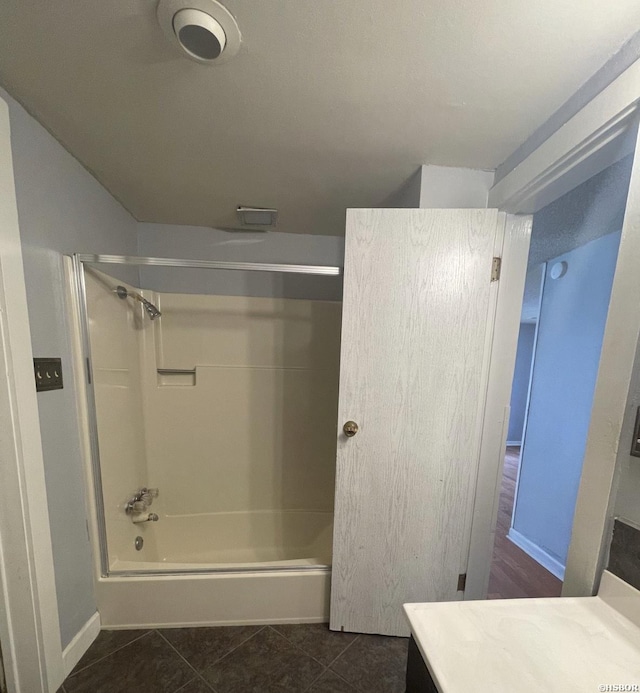 full bathroom with  shower combination, tile patterned flooring, baseboards, and vanity