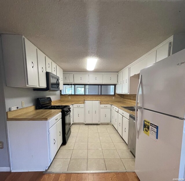 kitchen with light countertops, appliances with stainless steel finishes, and white cabinets