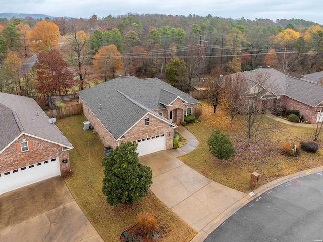 birds eye view of property with a view of trees