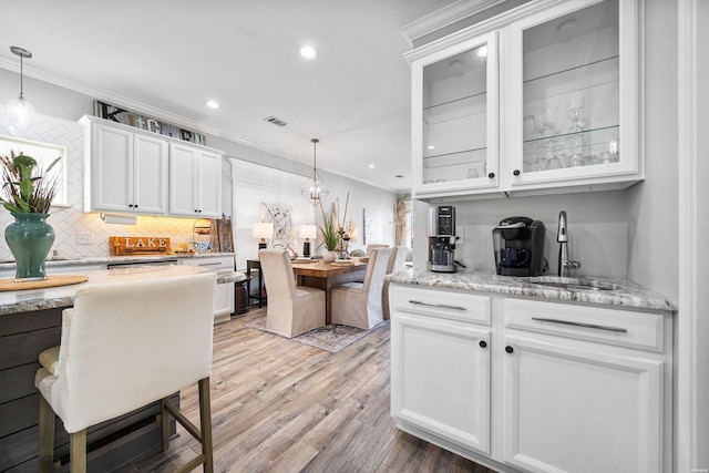 125 Eagle View Pt, Hot Springs, AR 71913 - kitchen with crown molding, white cabinets, backsplash, a sink, and glass insert cabinets
