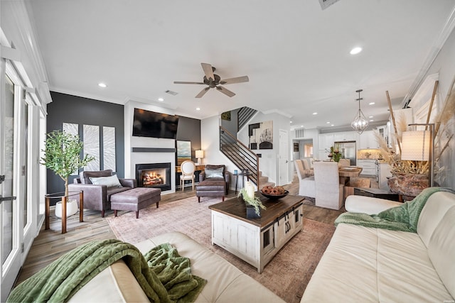 125 Eagle View Pt, Hot Springs, AR 71913 - living room featuring light wood finished floors, a glass covered fireplace, recessed lighting, crown molding, and a ceiling fan