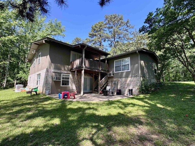 612 Independence, Hot Springs, AR 71913 - back of house featuring brick siding, a lawn, and a patio area