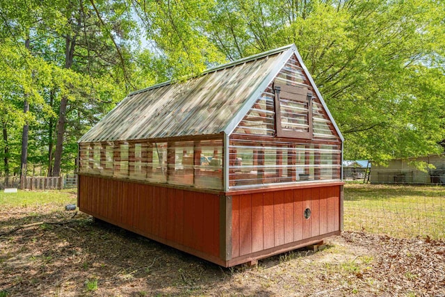 view of greenhouse featuring fence