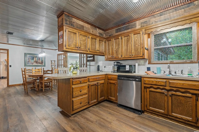 kitchen featuring light countertops, dishwasher, a sink, a peninsula, and brown cabinetry