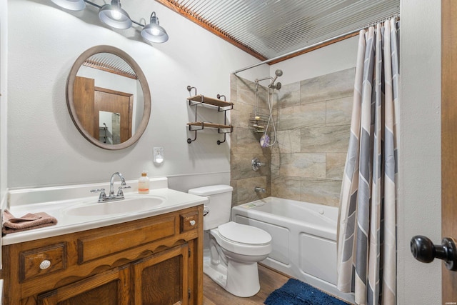 bathroom with wood finished floors, shower / bath combination with curtain, vanity, and toilet