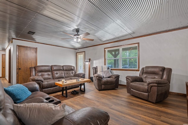 living room featuring ceiling fan, baseboards, wood finished floors, and visible vents