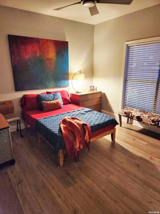 bedroom featuring a ceiling fan and wood finished floors