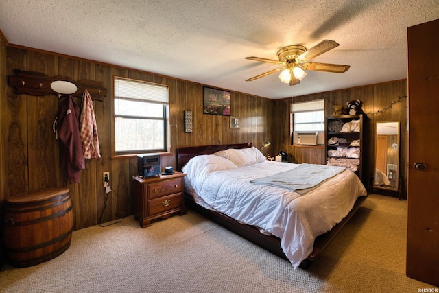 bedroom with wooden walls, cooling unit, a textured ceiling, and light colored carpet