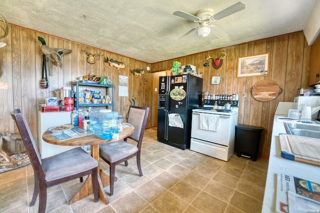 kitchen featuring brown cabinets, black refrigerator with ice dispenser, electric range, ceiling fan, and a textured ceiling