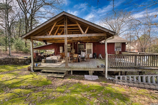 rear view of property featuring cooling unit, a deck, and an outdoor hangout area