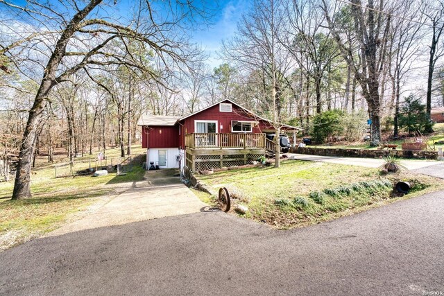 view of front of home with driveway, a front lawn, and a deck